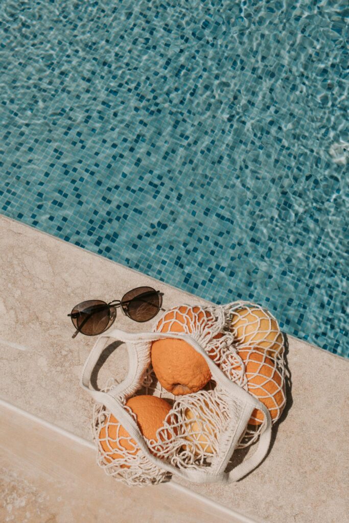 Basket Of Orange Fruits On Poolside