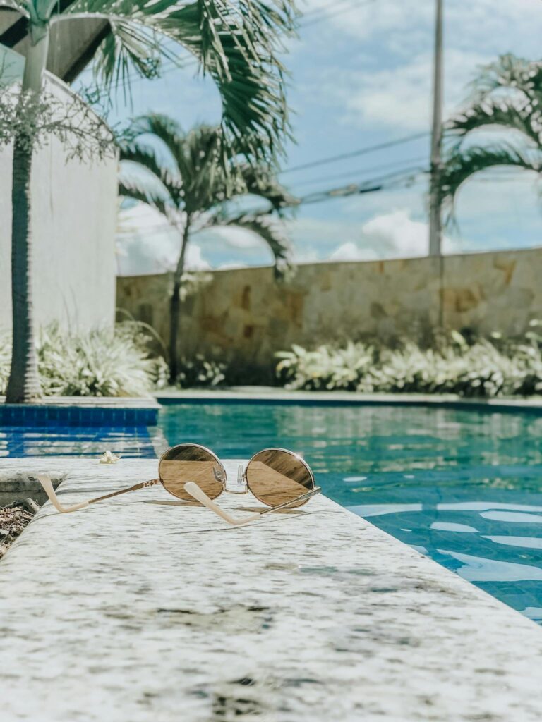 Brown Sunglasses Beside the Swimming pool